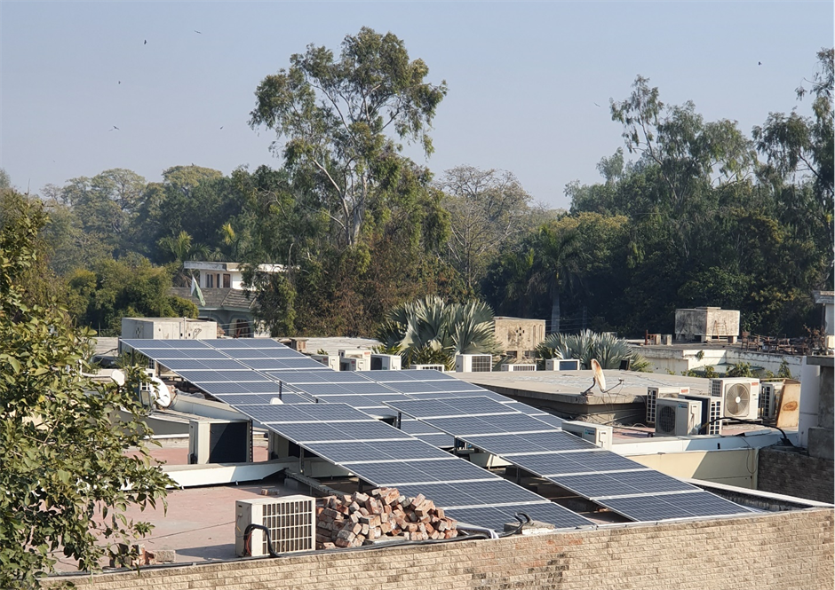 Solar modules fitted on the rooftop of an industrial building in Pakistan.